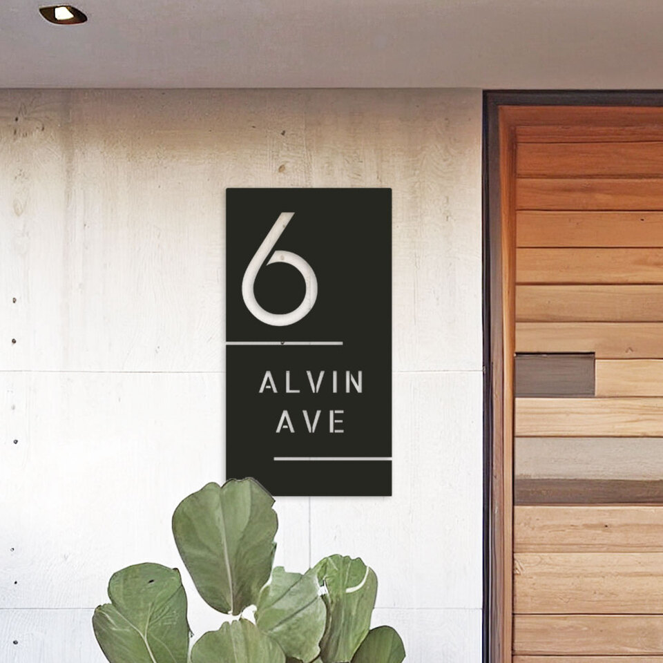modern black house address sign on a wall next to a cedar entrance door